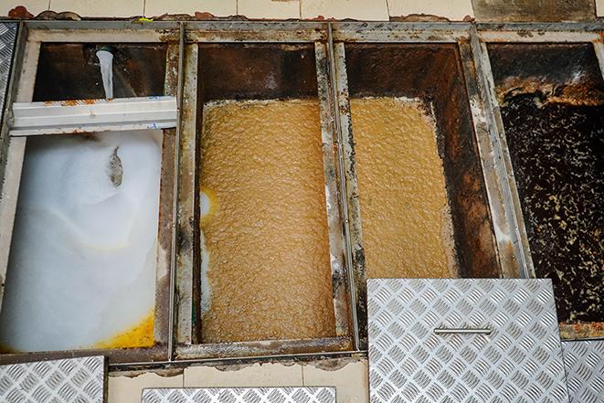 a grease trap undergoing thorough cleaning and maintenance